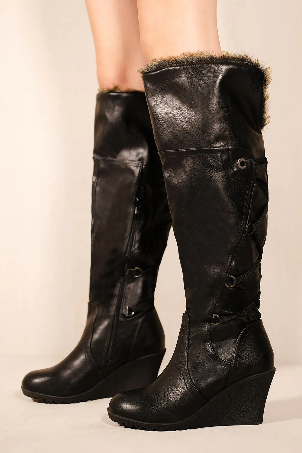 BRIDGET WEDGE HEEL MID CALF HIGH BOOTS WITH FUR & LACE UP DETAIL IN BLACK FAUX LEATHER